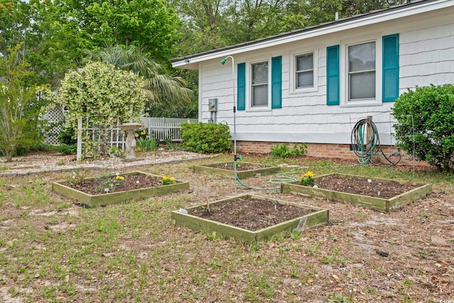 view of yard with a garden and fence