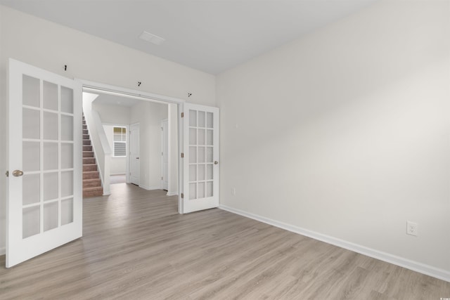 736 Flowering Branch Ave, Little River, SC 29566 - unfurnished room featuring french doors, light wood finished floors, and stairway