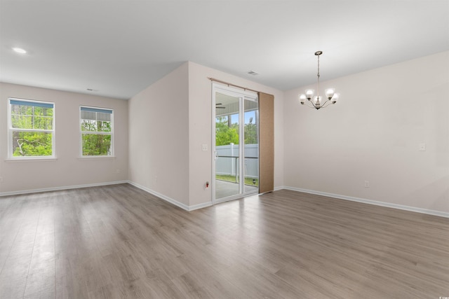 736 Flowering Branch Ave, Little River, SC 29566 - empty room with a chandelier and light wood finished floors