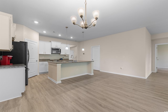 736 Flowering Branch Ave, Little River, SC 29566 - kitchen with stainless steel microwave, light wood-type flooring, white cabinetry, a chandelier, and recessed lighting