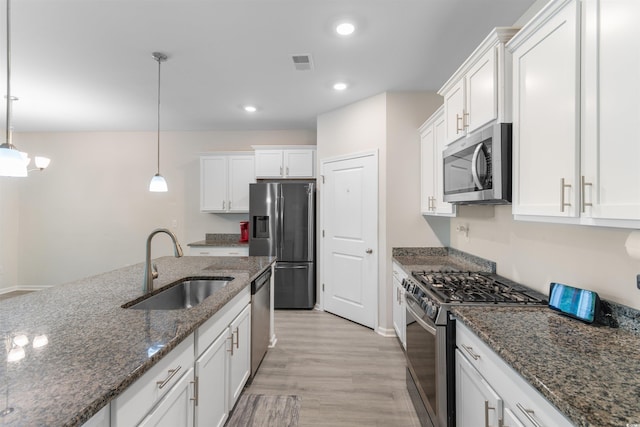 736 Flowering Branch Ave, Little River, SC 29566 - kitchen with appliances with stainless steel finishes, light wood finished floors, white cabinets, recessed lighting, and hanging light fixtures