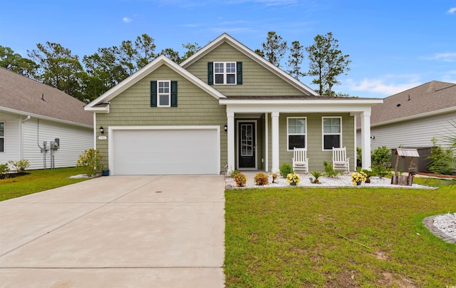 736 Flowering Branch Ave, Little River, SC 29566 - view of front of property featuring a porch, driveway, a front lawn, and a garage