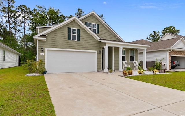 736 Flowering Branch Ave, Little River, SC 29566 - view of front facade with covered porch, driveway, a front lawn, and an attached garage