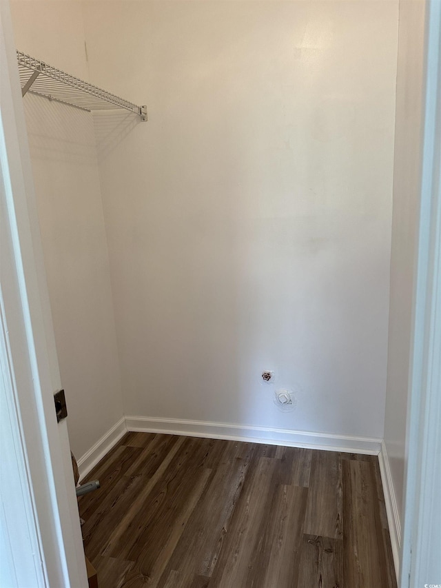 walk in closet with dark wood-type flooring