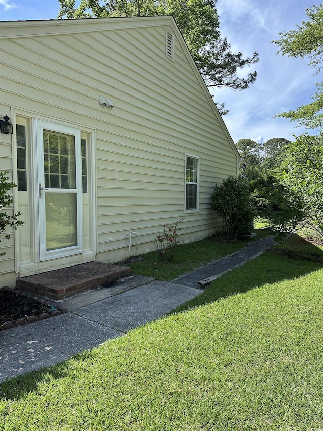 view of side of home featuring a lawn