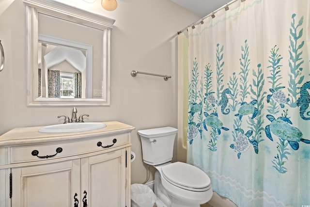 bathroom featuring toilet, vanity, and a shower with shower curtain