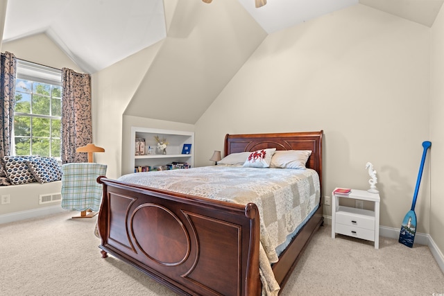 bedroom with vaulted ceiling, light colored carpet, baseboards, and ceiling fan
