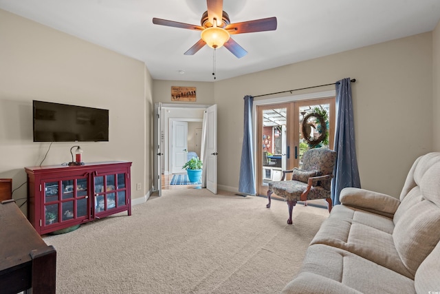 living area featuring french doors, carpet, a ceiling fan, and baseboards