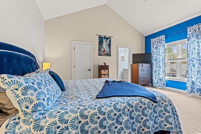 carpeted bedroom featuring high vaulted ceiling