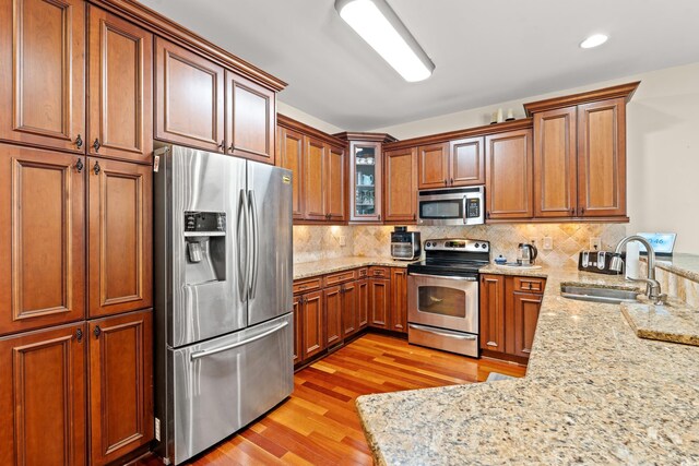 2019 Ye Olde Kings Hwy, North Myrtle Beach, SC 29582 - kitchen with stainless steel appliances, a sink, light wood-type flooring, a peninsula, and tasteful backsplash