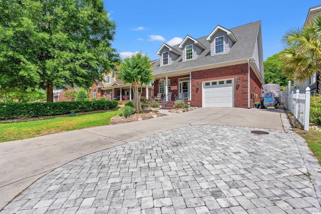 2019 Ye Olde Kings Hwy, North Myrtle Beach, SC 29582 - cape cod home featuring brick siding, decorative driveway, covered porch, and an attached garage