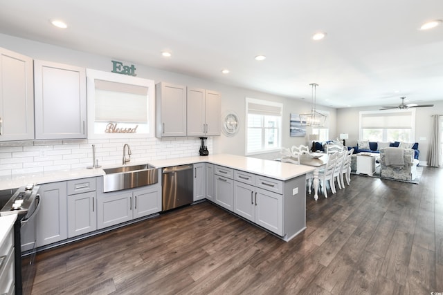 113B 11th Ave S, Surfside Beach, SC 29575 - kitchen featuring appliances with stainless steel finishes, a peninsula, dark wood finished floors, healthy amount of natural light, and recessed lighting