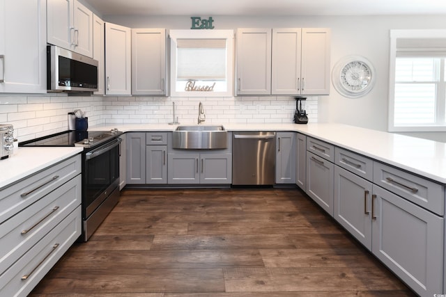 113B 11th Ave S, Surfside Beach, SC 29575 - kitchen featuring appliances with stainless steel finishes, gray cabinets, backsplash, and light countertops
