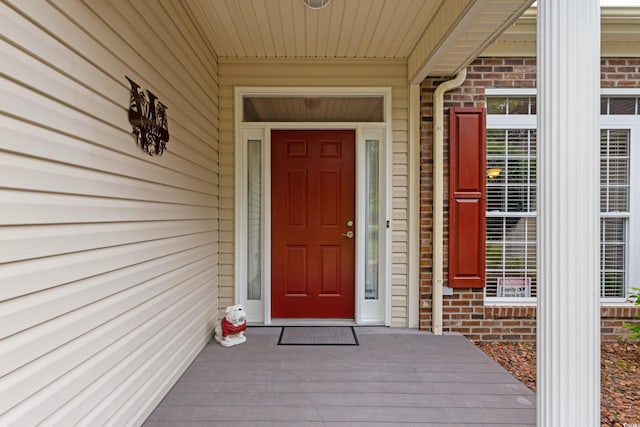 doorway to property with brick siding