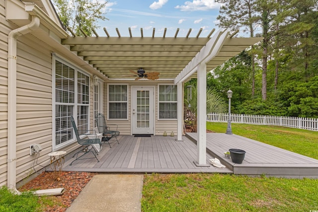 wooden deck featuring a ceiling fan and a pergola