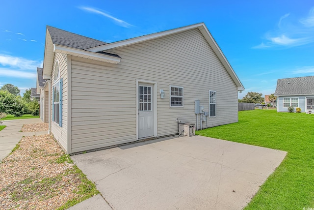 back of property featuring a patio area, a yard, and cooling unit