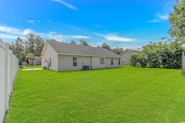 rear view of property featuring central AC unit
