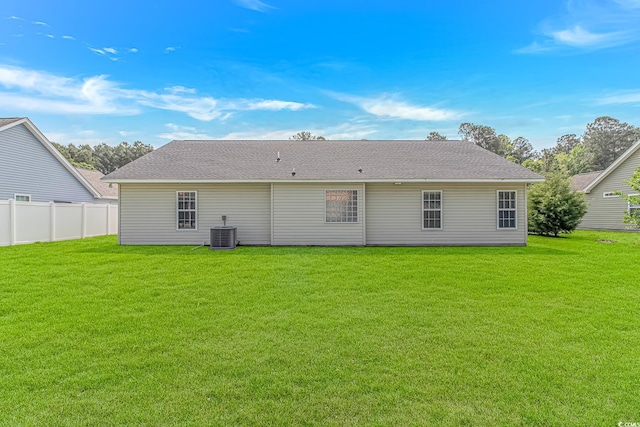 back of house with central AC unit