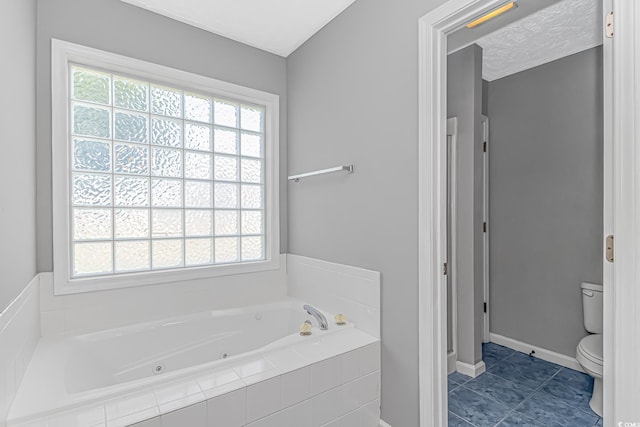 full bathroom featuring plenty of natural light, toilet, a jetted tub, and baseboards