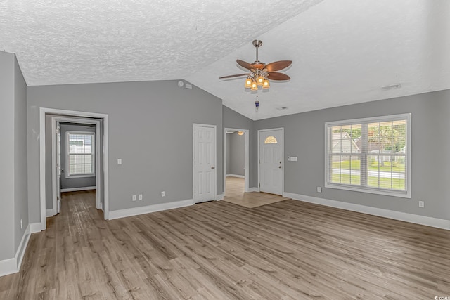 125 Balsa Dr, Longs, SC 29568 - unfurnished living room with a ceiling fan, light wood-style flooring, lofted ceiling, healthy amount of natural light, and a textured ceiling