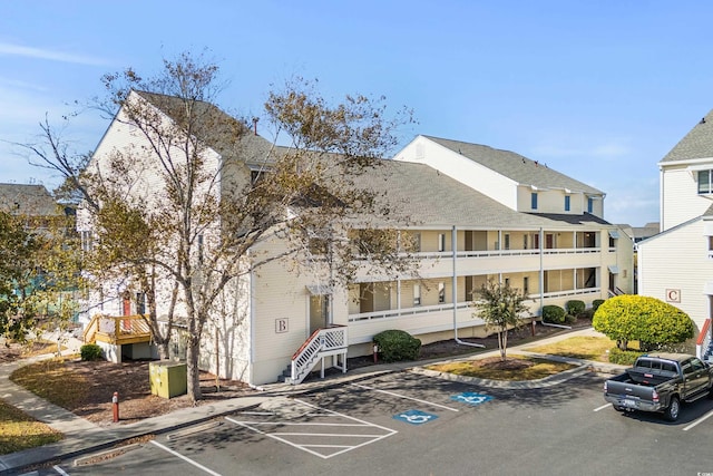 1100 Possum Trot Rd Unit B202, North Myrtle Beach, SC 29582 - view of property featuring uncovered parking and stairs