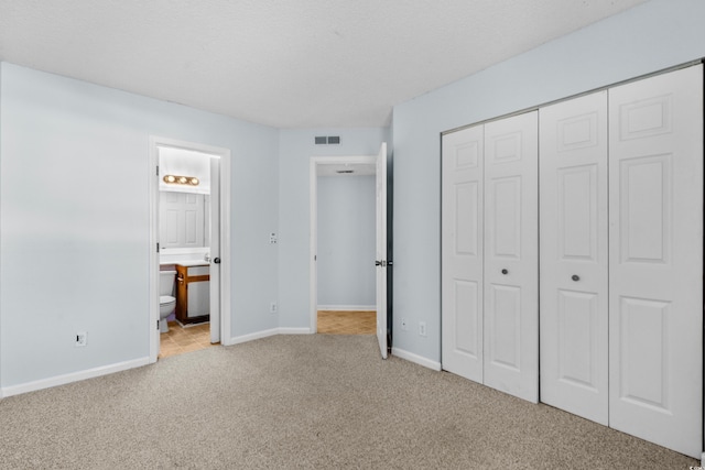 1100 Possum Trot Rd Unit B202, North Myrtle Beach, SC 29582 - unfurnished bedroom featuring carpet floors, a closet, baseboards, and ensuite bathroom