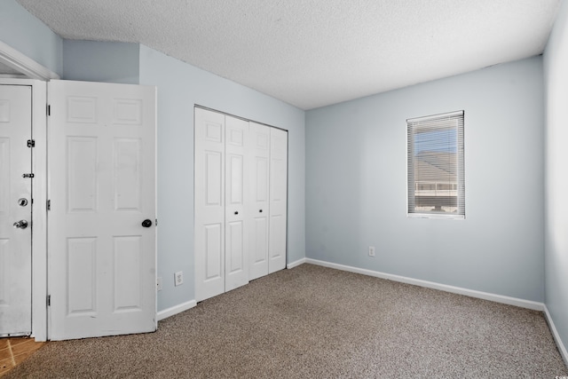 1100 Possum Trot Rd Unit B202, North Myrtle Beach, SC 29582 - unfurnished bedroom with carpet, a textured ceiling, a closet, and baseboards