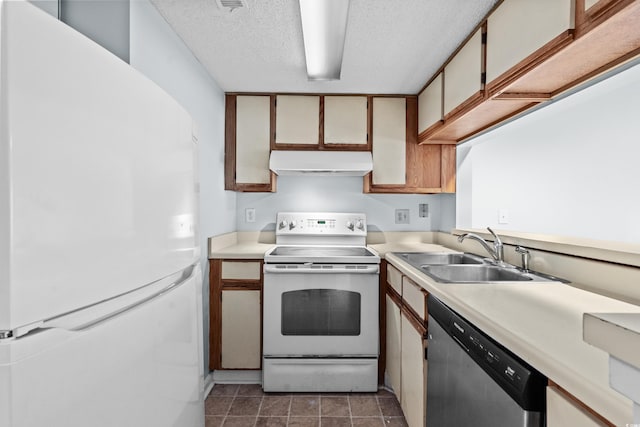 1100 Possum Trot Rd Unit B202, North Myrtle Beach, SC 29582 - kitchen with white appliances, under cabinet range hood, a sink, light countertops, and a textured ceiling