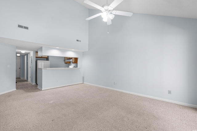 1100 Possum Trot Rd Unit B202, North Myrtle Beach, SC 29582 - unfurnished living room with light carpet, a ceiling fan, baseboards, and a towering ceiling