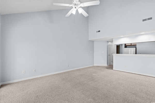 1100 Possum Trot Rd Unit B202, North Myrtle Beach, SC 29582 - unfurnished living room with carpet, baseboards, ceiling fan, and a high ceiling