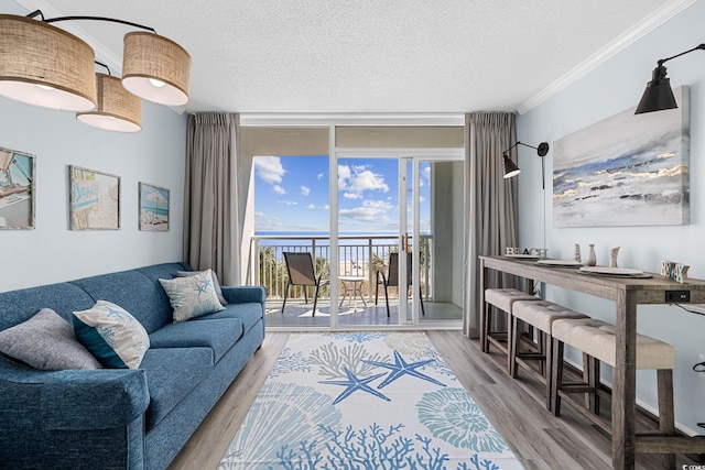 2000 N Ocean Blvd Unit 315, Myrtle Beach, SC 29577 - living area with a wall of windows, a textured ceiling, crown molding, and wood finished floors