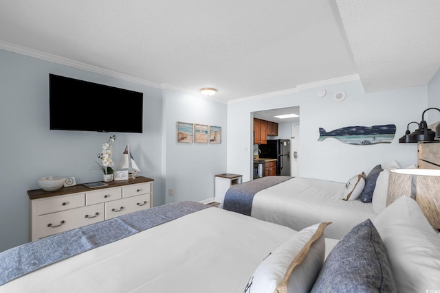 bedroom featuring ornamental molding, freestanding refrigerator, a textured ceiling, and baseboards