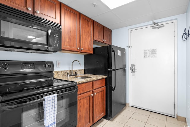 2000 N Ocean Blvd Unit 315, Myrtle Beach, SC 29577 - kitchen with black appliances, a sink, light stone counters, a drop ceiling, and light tile patterned flooring