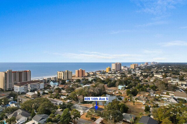 aerial overview of property's location with nearby urban area and a large body of water