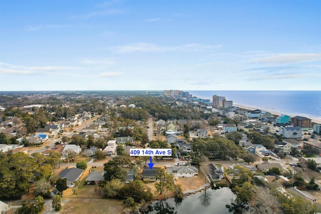 aerial view of property's location featuring a nearby body of water, nearby urban area, and nearby suburban area