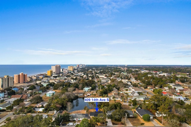 aerial view of property and surrounding area with a nearby body of water