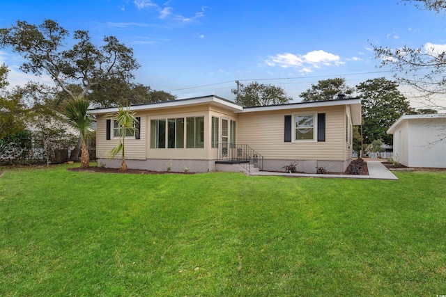 rear view of property with a yard