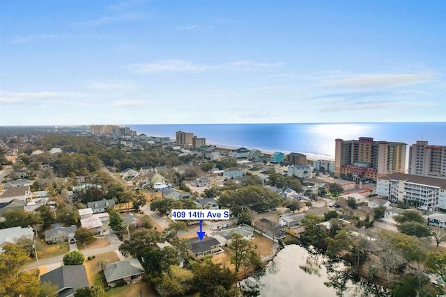 aerial overview of property's location with a nearby body of water and nearby urban area