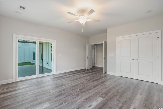 61 Yale Pl, Pawleys Island, SC 29585 - unfurnished bedroom featuring wood finished floors, baseboards, ceiling fan, and access to outside