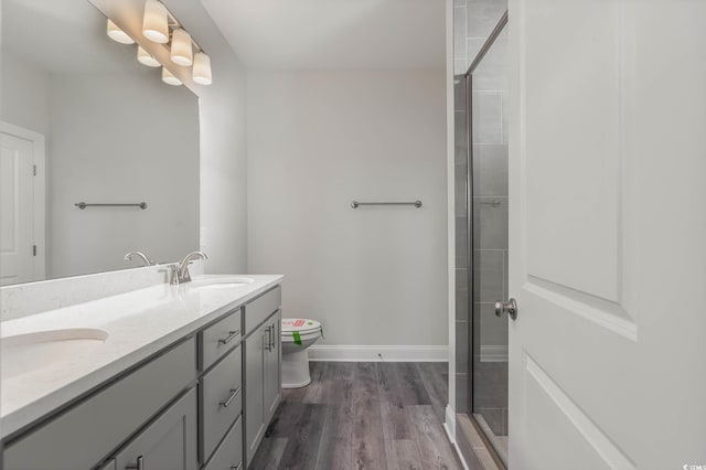 61 Yale Pl, Pawleys Island, SC 29585 - full bathroom with toilet, wood finished floors, tiled shower, double vanity, and baseboards