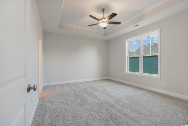 61 Yale Pl, Pawleys Island, SC 29585 - spare room with a raised ceiling, ornamental molding, a ceiling fan, carpet floors, and baseboards