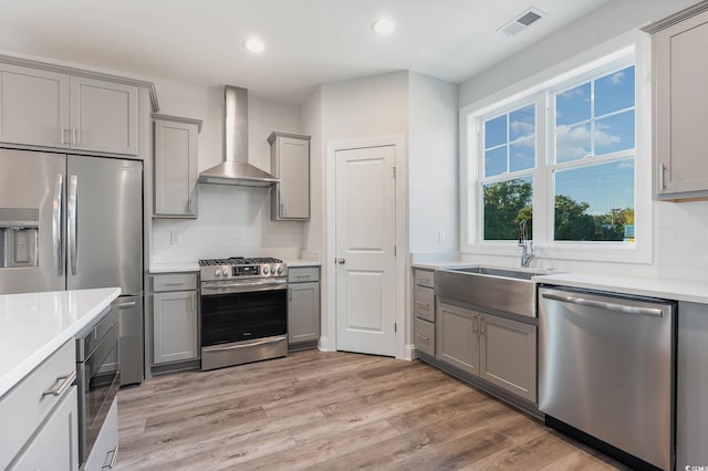 61 Yale Pl, Pawleys Island, SC 29585 - kitchen featuring appliances with stainless steel finishes, gray cabinetry, wall chimney range hood, and recessed lighting