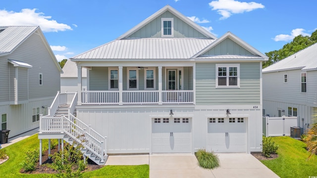 61 Yale Pl, Pawleys Island, SC 29585 - beach home with board and batten siding, driveway, an attached garage, covered porch, and stairs