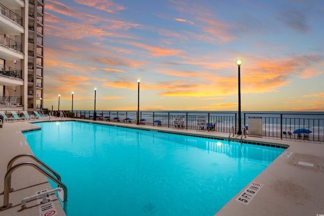 1690 N Waccamaw Dr Unit 103, Garden City Beach, SC 29576 - community pool featuring a water view, fence, and a patio