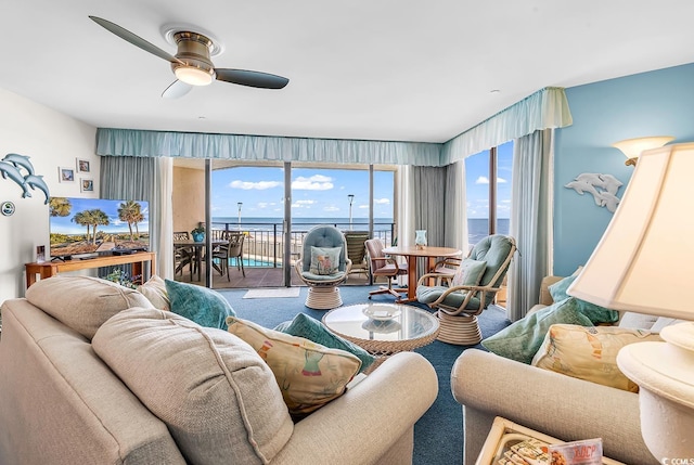1690 N Waccamaw Dr Unit 103, Garden City Beach, SC 29576 - living area featuring a water view, ceiling fan, carpet flooring, and plenty of natural light