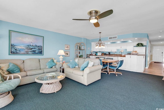1690 N Waccamaw Dr Unit 103, Garden City Beach, SC 29576 - living area featuring ceiling fan, recessed lighting, dark carpet, and a chandelier