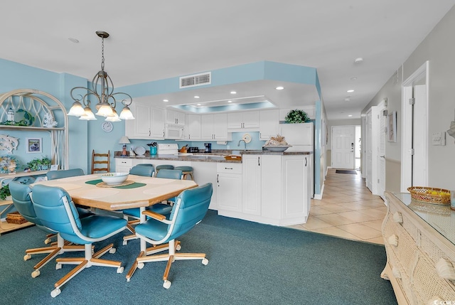 1690 N Waccamaw Dr Unit 103, Garden City Beach, SC 29576 - dining area with recessed lighting, light tile patterned floors, and light carpet