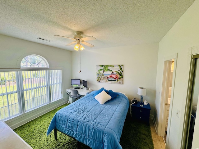 4783 Wild Iris Dr Unit 101, Myrtle Beach, SC 29577 - bedroom with ceiling fan and a textured ceiling