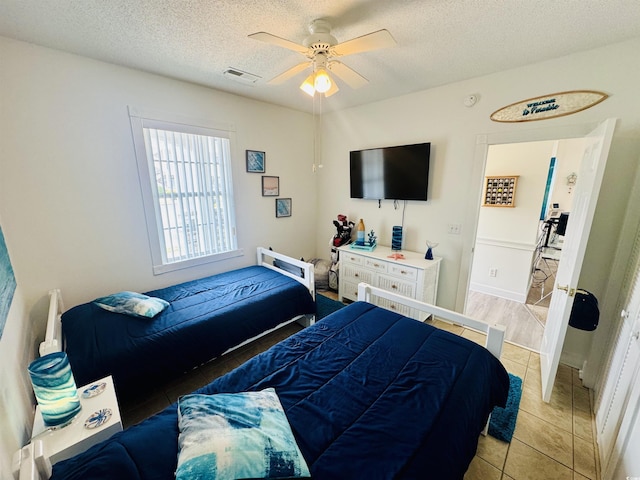 4783 Wild Iris Dr Unit 101, Myrtle Beach, SC 29577 - bedroom with light tile patterned flooring, a textured ceiling, and ceiling fan