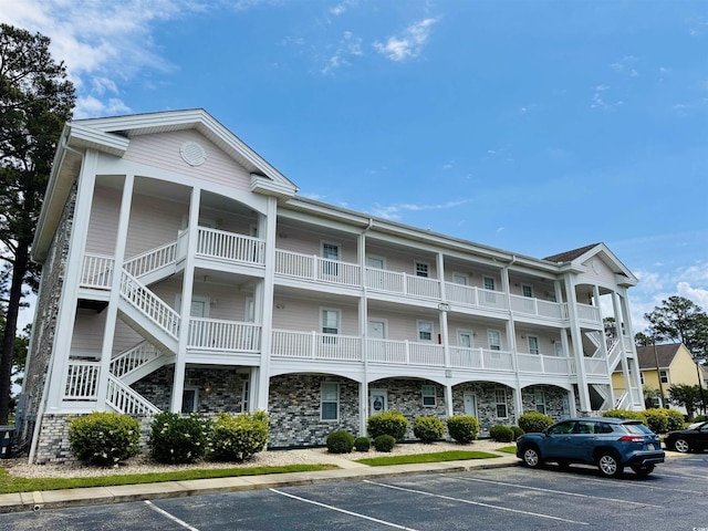 4783 Wild Iris Dr Unit 101, Myrtle Beach, SC 29577 - view of building exterior with uncovered parking and stairway